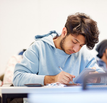 Man writing at a desk